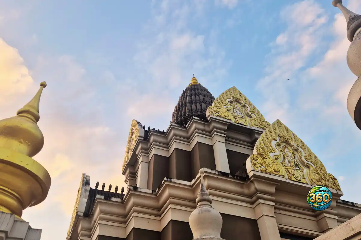 Vue en contre-plongée du grand chedi du Wat Chalong à Phuket avec décorations dorées et ciel nuageux